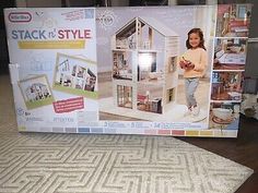 the box is open to show it's contents and instructions for making a doll house