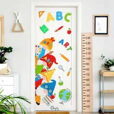 a child's growth chart is on the wall next to a door with a ruler in front of it