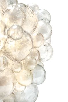 a bunch of glass balls sitting on top of each other in front of a white background