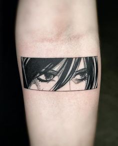 a woman's arm with a black and white tattoo on it