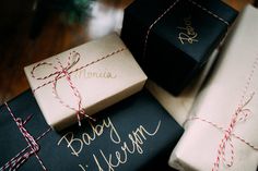 presents wrapped in black and white paper with red twine