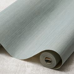 a roll of gray colored paper on the floor