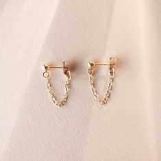 Amp up your ear game with these modern + dainty Chain Loop Studs! DETAILS * Sold as a pair with matching backings. * Available in 14k Gold Filled, 14k Rose Gold Filled, Sterling Silver or Solid 14k Yellow Gold. * The ball at the top of the stud measures 3mm across. * The chain has a total length of 1" and a hanging length of about 1/2". We have a shorter, chain cuff version available here: https://etsy.me/2ZfVO6E These earrings can be made in any length, so if you are looking for the chain to be Loop Earrings Gold, Earrings Edgy, Tiger Earrings, Chain Loop, Minimalist Gifts, Loop Earrings, Silver Earrings Dangle, Gold Filled Jewelry, Gold Studs