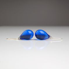 "These Small dark blue teardrop earrings are made of glass in lampwork technique. The earrings hooks are sterling silver and are hypoallergenic. These unique and beautiful earrings are like water drops frozen in glass! They are simple and elegant, very lightweight and comfortable to wear, perfect for everyday wear and for special occasions. 💕 You will definitely receive lots of compliments on your new earrings, everybody loves them, and you'll love them too! Dimensions: total length about 1 1/8 Blue Pear-shaped Teardrop Earrings, Modern Blue Long Drop Earrings, Modern Blue Teardrop Jewelry, Modern Blue Long Drop Jewelry, Modern Blue Teardrop Earrings, Blue Pear-shaped Earrings For Gift, Blue Teardrop Drop Earrings, Blue Teardrop Earrings With Ear Wire, Blue Nickel-free Long Drop Teardrop Earrings