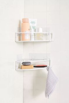 two white shelves with hair products on them and a towel hanging from the wall next to each other