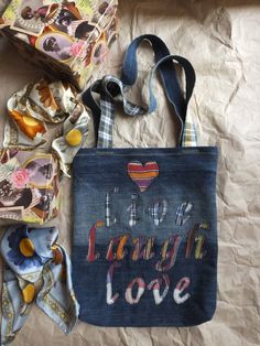 a denim bag with the words i love my daughter and two matching bandannas