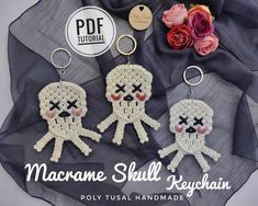 three crocheted keychains with skulls on them and flowers in the background