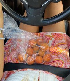 there is a plastic bag full of nuts in the back seat of a car