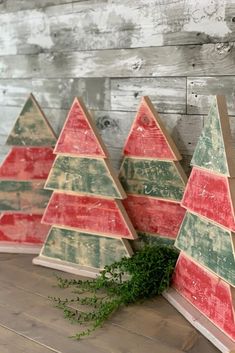 three wooden christmas trees sitting on top of a table