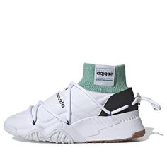 The Adidas Alexander Wang x Puff Trainer 'Core White' is a stylish and comfortable sneaker that is perfect for everyday wear. Made with a synthetic leather upper, this shoe is durable and easy to clean. The tonal stitch detailing gives the shoe a 'puffer' effect, while the green sock-like collar adds a pop of color. The woven logo tag and inverted Trefoil branding add a touch of luxury to this shoe. The oversized drawcord lacing system ensures a secure fit, while the gum rubber outsole provides excellent traction. (SNKR) Sporty Slip-on Sneakers For Streetwear With White Sole, Sporty Lace-up Basketball Shoes With Vulcanized Sole, Athleisure Sneakers With Boost Midsole And Round Toe, Sporty Mid-top Chunky Sneakers With Vulcanized Sole, Modern Mid-top Sneakers For Light Sports, Streetwear Slip-on Sneakers With Boost Midsole, Modern Basketball Shoes With Vulcanized Sole, Functional Sneakers With Vulcanized Sole, Modern High-top Sneakers For Light Sports With Cushioned Footbed