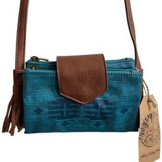 Catchfly Western Tassel Wanderlust Turquoise Wallet Crossbody Bag By Trenditions. Crossbody W/ Wristlet And Strap Turquoise Coated Canvas With Arrows 2 Snap And Zip Closures 1 Zip Pocket 1 Front Pocket Zip Top Closure Approx. Measurements: 7.25"W X 1"D X 4.5"H Dl 27" Please Note: Has Some Slight Discoloration On The Inner Pocket Areas. Review The Sixth Photo For Your Consideration. I Have Not Tried Cleaning It So I Don’t Know If That’d Help Or Not. No Other Flaws! Turquoise Rectangular Wallet For Everyday Use, Blue Bohemian Clutch For Everyday Use, Blue Bohemian Clutch For Daily Use, Bohemian Blue Clutch For Daily Use, Crossbody Wallet Purse, Card Purse, Leather Camera Bag, Small Crossbody Purse, Juicy Couture Bags