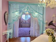 a bedroom with pink walls and blue curtains