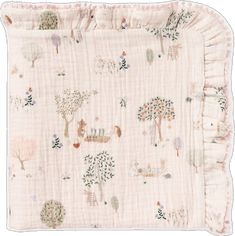 a baby blanket with animals and trees on the front, in light pink linens