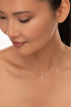 The perfect sparkler to feature solo or stack alongside other solid gold staples. Featuring expertly drilled diamonds that appear to be floating on a lustrous 14k gold chain. A never-take-off piece to wear on rotation. Everyday Luxury Diamond Necklace With Accents, Dainty Round Station Necklace With Diamond Accents, Dainty Cubic Zirconia Necklace With Diamond Accents, Dainty Station Necklace With Diamond Accents, Dainty Station Necklace With Single Cut Diamonds, Dainty Station Necklace With Diamond Accents For Formal Events, Delicate Diamond Station Necklace, Dainty Station Necklace With Diamond Accents For Anniversary, Luxury Diamond Station Necklace With Delicate Chain