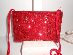 "A vintage red beaded evening bag. This is a small bag covered with red sequins and beading. The bag interior is red taffeta with one pocket. The bag has a zipper closing. This is a sparkly red bead clutch bag plus a cord strap to wear on your shoulder or cross body. A glamorous special occasion bag or red after five bag. MATERIAL: Beading, taffeta CONDITION: It is in good condition SIZE: It measures 7\" wide and 4 1/2\" high COLOR: Red" Red Embellished Clutch Shoulder Bag, Red Beaded Evening Bag For Party, Red Beaded Clutch Evening Bag, Red Embellished Evening Bag For Festive Occasions, Festive Red Embellished Evening Bag, Red Clutch Evening Bag For Festive Occasions, Red Beaded Evening Bag As Gift, Festive Red Clutch Evening Bag, Red Rectangular Evening Bag For Festive Occasions