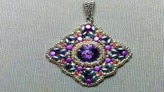 a purple and black beaded pendant on a white background