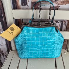 Turquoise Colored Croc Embossed Kiss In Lock Handbag. Antiqued Hardware. Nwt As Seen In Photos. Please Reference All Pictures They're An Important Part Of The Description And Sizing. All Reasonable Offers Welcomed. I Offer Same Day Ship Or Next Try Bundling For Savings Luxury Turquoise Top Handle Bag, Light Blue Travel Bag With Removable Pouch, Light Blue Shoulder Bag Satchel For Travel, Blue Handheld Shoulder Bag For Travel, Luxury Turquoise Travel Bags, Blue Top Handle Shoulder Bag, Blue Leather Box Bag With Handles, Light Blue Leather Satchel With Top Handle, Light Blue Leather Satchel With Detachable Strap