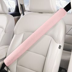 a pink seat belt in the back of a car