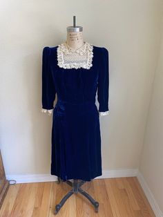 "Vintage 1930s 40s Silk Velvet Blue with Lace Collar Free Shipping This dress so beautiful!  It is homemade out of pretty royal blue silk velvet fabric. The seams are sewn by machine and the lace is hand sewn on. The covered buttons, amazingly, are all there. The dress is midi length and hits just below the knee. the sleeves have shoulder pads and are three quarter length. Since I'm not sure of the size, please use the measurements for the correct fit. There are no major flaws apparent that I can see.  Measurements  Shoulders across 14\" Bust 38\" Waist 28\" Hips 38\" Length shoulder to hem 41\"" Velvet Dress Blue, Silk Velvet Dress, Silk Velvet Fabric, Blue Velvet Dress, 1940s Fashion, House Dress, Lace Collar, Blue Silk, Silk Velvet