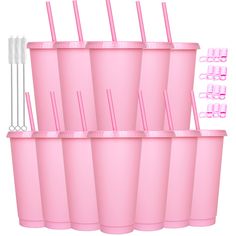 six pink cups with straws and toothbrushes in them are stacked on top of each other