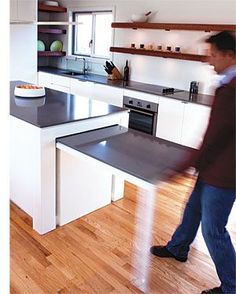 a man standing in front of a kitchen counter