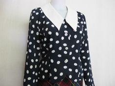 "Liz Claiborne Peplum Blouse ~Sassy~ Polka Dot Blouse ~This is a WOW~ Beautifully tailored and fitted Poly crepe A bit dress up! Button front Peplum waist Shoulder pads have been removed Small 4 Petite Bust 38\" Waist 30\" Hip 40\" Shoulder 16\" Length 19\" Excellent condition Looks unworn! https://www.etsy.com/shop/BelindasStyleShop" Retro Fitted Polka Dot Blouse, Vintage Polka Dot Blouse For Work, Vintage Polka Dot Blouse For Workwear, Classic Fitted Polka Dot Blouse, Fitted Polka Dot Blouse For Work, Chic Fitted Blouse With Peter Pan Collar, Fitted Retro Workwear Blouse, Vintage Tailored Polka Dot Blouse, Fitted Vintage Polka Dot Blouse