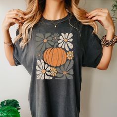 This boho style pumpkin t-shirt is the perfect addition to your fall wardrobe. With its cozy vibes and playful Halloween design, it's sure to be a hit at any autumn event. Express your love for the season in a stylish and unique way. Trendy Screen Print T-shirt For Fall, Orange Graphic Print T-shirt For Fall, Bohemian Short Sleeve T-shirt For Fall, Fall Graphic Tee Soft-washed, Bohemian Crew Neck T-shirt For Fall, Bohemian Fall Crew Neck T-shirt, Fall Bohemian Crew Neck T-shirt, Vintage Relaxed Fit T-shirt For Fall, Cute Fall T-shirt With Screen Print