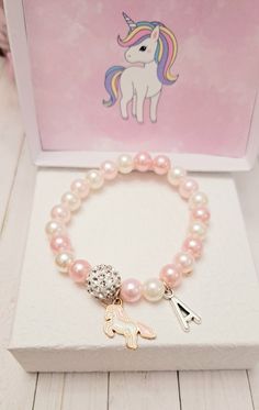 This beautiful Unicorn Charm bracelets is the perfect gift for someone special. The bracelet is made of high-quality beads. This makes an excellent gift for yourself or your friends and family members.  The bracelet is made with a high-quality beads. Product Details: - Material: stretchy string,pink and white 8 mm pearl beads, Unicorn and 10mm rhinestone crystal bead. Product Details Length:  Toddler- 5.5 inches S- 6.5 inches M- 7 inches L- 7.5 inches Xl- 8 inches.  Please reach out to me for cu Pink Beaded Jewelry Birthday Gift, Pink Beaded Jewelry For Birthday Gift, Pink Charm Bracelet For Birthday, Pink Round Bead Bracelets For Birthday Gift, Pink Round Beads Bracelets For Birthday Gift, Pink Round Beads Bracelet For Birthday, Pink Charm Bracelets For Birthday Gift, Pink Charms Bracelets For Birthday Gift, Pink Beaded Bracelets For Birthday