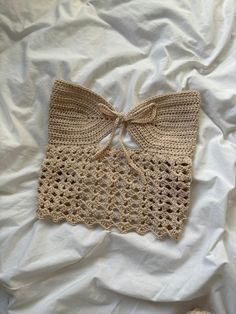 there is a crocheted bow on the bed