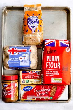 an old metal tray filled with different types of bread and other food items on top of it