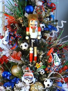 a christmas tree decorated with soccer ornaments and nutcrackers is pictured in this image