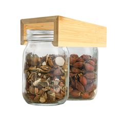 two glass jars with nuts in them and a wooden lid on the top one is open