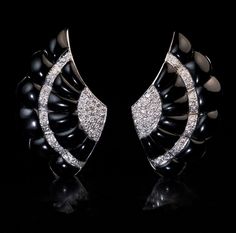 1930s Superbly modeled in high Art Deco taste, these 18K white gold clip earrings are designed as a pair of stylized wings. The earrings are set with finely carved and polished black onyx panels with diamond accents. Estimated total diamond weight is 1.10 ct. Length 39 mm (1 1/2 in.) Width 25 mm (15/16 in.) Weight 9 grams each. The earrings are marked with 750 gold standard (18K). Available Convertible Earrings, Vintage Art Deco Rings, Faberge Eggs, Earrings Antique, Gold Clips, Deco Vintage, Gold Brooches, Art Deco Earrings, High Art