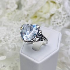 10ct. White CZ (Cubic Zirconia) 925 Sterling Silver RingHeart Leaf Design#D213 This Gothic inspired lovely filigree ring is set with a 10ct flawless White CZ (Cubic Zirconia) . This heart gemstone is 15mm x 15mm. The rings sits 11mm off the finger. Notice the beautiful gothic design of the silver filigree setting and band. The inside of the band is marked 925 for sterling silver. This is an exquisite rendition of an antique filigree ring. The sterling filigree cradles the stone in a delicate car Elegant Heart Cut Crystal Ring For Valentine's Day, Elegant Cubic Zirconia Crystal Ring For Valentine's Day, Elegant Crystal Ring With Cubic Zirconia For Valentine's Day, Elegant Heart Cut Crystal Ring Gift, Elegant Diamond Crystal Ring For Valentine's Day, Elegant Heart-shaped Crystal Ring For Anniversary, Formal Heart-shaped Ring In Cubic Zirconia, Formal Heart-shaped Ring With Cubic Zirconia, Formal Heart-shaped Cubic Zirconia Ring