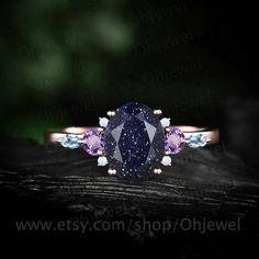 "This is a lab blue sandstone engagement ring in solid gold,about 6x8mm oval cut. The accent stones are natural 3mm amethyst,round opals and marquise cut 1.5x3mm topaz. The band width is about 1.4mm. It can be made in any ring size. However please contact me to custom make it to a special big or small size. It can be made in white gold,rose gold or yellow gold with 14k or 18k. However for some people who are nickel allergic,I can also make it to 925 sterling silver to make you can wear it. The r Dainty Sapphire Birthstone Jewelry, Anniversary Multi-stone Round Cut Jewelry, Anniversary Jewelry With Multi-stone Round Cut, Dazzling Multi-stone Sapphire Jewelry, 14k Gold Multi-stone Oval Jewelry, Oval Multi-stone 14k Gold Jewelry, Elegant Gemstones With Prong Setting For Promise Ring, Dazzling 14k Gold Multi-stone Jewelry, Dazzling Multi-stone 14k Gold Jewelry