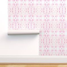 an empty room with pink wallpaper and a white roller