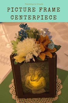 there is a small box with flowers and bananas in it that says picture frame centerpiece