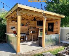 an outdoor kitchen is built into the side of a shed