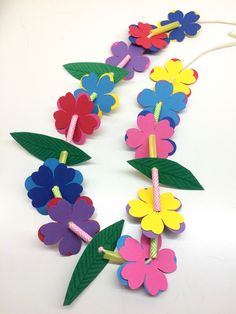 colorful paper flowers and leaves on a string