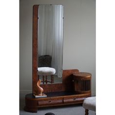 a mirror sitting on top of a wooden dresser