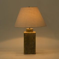 a lamp that is on top of a table with a white light in the background