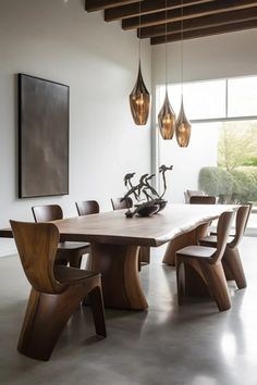 a dining room table and chairs in front of a large window with lights hanging from the ceiling