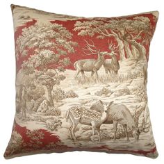 a red and white pillow with deer in the woods on it's side, surrounded by trees