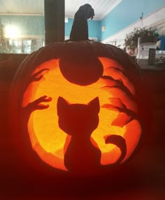 a carved pumpkin with an image of a cat on it