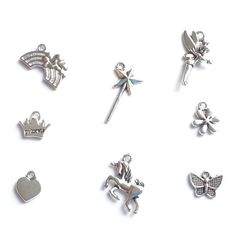 several different types of charms on a white surface