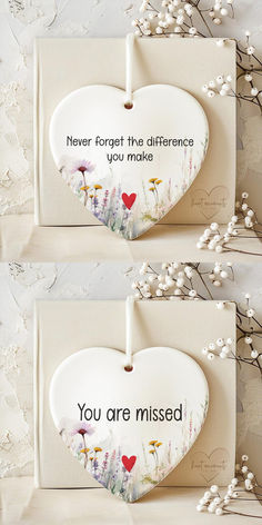 two heart shaped plaques with flowers on them and the words you are missed written in black ink