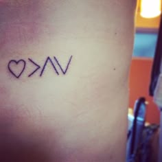 the word vak is written in black ink on a woman's lower arm