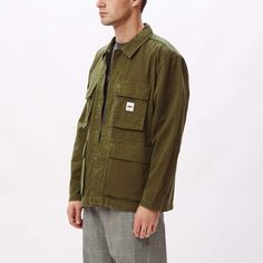 The Peace BDU (Battle Dress Uniform) jacket is constructed of 100% organic cotton and features a vintage look, full-zip closure with snap placket closure, four button closure pockets at front and a woven logo label sewn at chest. 100% organic cotton. Machine wash cold. Imported. By OBEY.Style: 121800440 Cotton Utility Jacket With Long Sleeves For Streetwear, Cotton Long-sleeved Utility Jacket For Streetwear, Cotton Shacket With Button Closure For Streetwear, Utility Shacket For Streetwear, Utility Long Sleeve Shacket For Streetwear, Khaki Utility Jacket With Patch Pockets, Streetwear Button-up Shacket, Casual Streetwear Shacket With Patch Pockets, Casual Shacket With Multiple Pockets For Streetwear