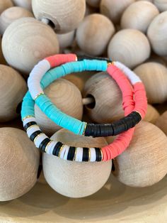 "This listing is for a set of TWO coral/white/black and aqua bracelets. The small heishi beads are 6mm. My hand-beaded bracelets are made with stretch elastic which makes it comfortable and easy to wear. They are made to fit an average wrist size of 6.5\"-7\". Take a look around my shop for additional colors to add to your stack! I've included pictures to give you an idea of bracelets to add to your set." Polymer Bead Bracelets, Homemade Beaded Bracelets, Clay Bracelets Diy, Polymer Clay Bracelet Ideas, Polymer Bracelets, Polymer Clay Bead Bracelet, Polymer Clay Bracelets, Clay Beaded Bracelets, Bracelets Preppy