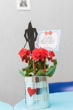 a tin can with some red roses in it and a paper cutout that says i love you